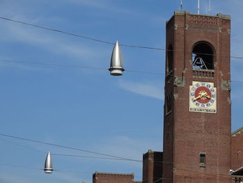 Low angle view of text on building against sky