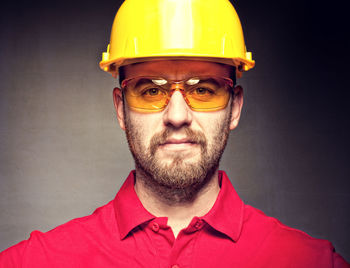 Portrait of engineer in protective workwear against wall