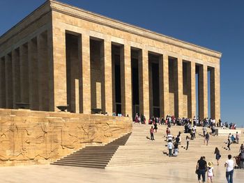 Tourists visiting an?tkabir against clear blue sky during sunny day