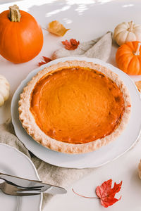 Fall season pumpkin pie on the plate close-up. traditional autumn food