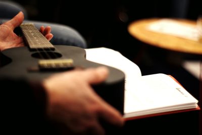 Close-up of man playing guitar
