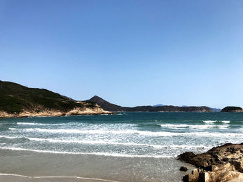 Scenic view of sea against clear blue sky