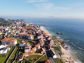 High angle view of townscape by sea against sky