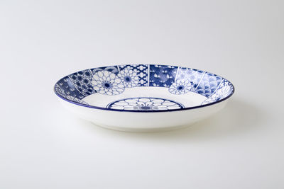 High angle view of blue glass on white background