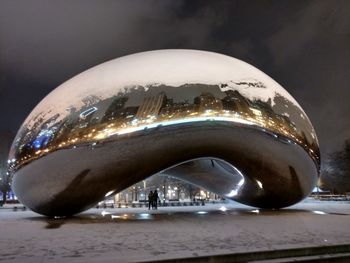 Close-up of illuminated city against sky at night