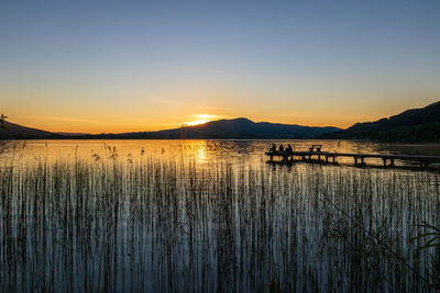 Scenic view of lake against sky during sunset