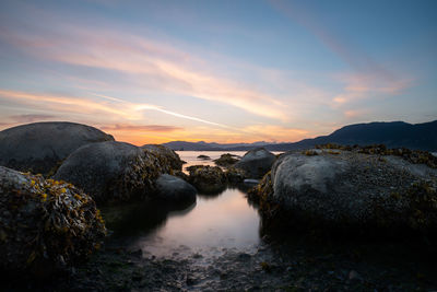 Scenic view of rocks against sky during sunset