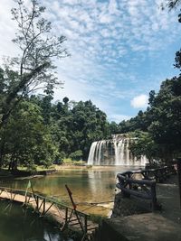 Scenic view of river against cloudy sky