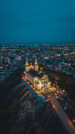 High angle view of illuminated buildings in city at night