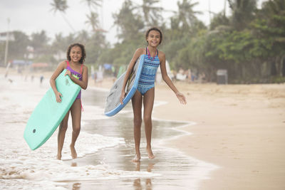 Portrait of happy friends on beach