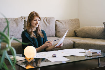 Young woman using laptop while sitting at home