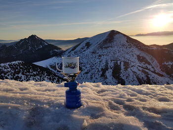 Snow covered mountain against sky during sunset