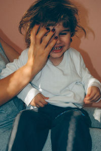 Girl sitting with mother at home