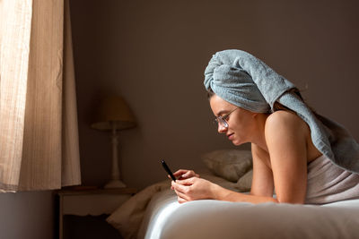 Side view of woman using mobile phone