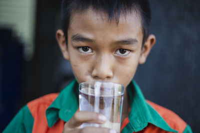 Close-up portrait of boy drinking drink