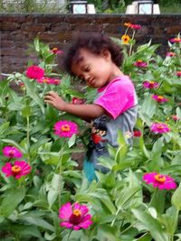 Side view of girl with pink flowering plants