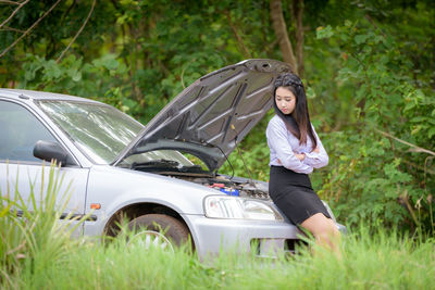 Woman standing in a car