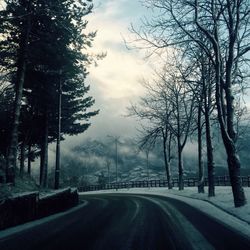 Empty road against cloudy sky