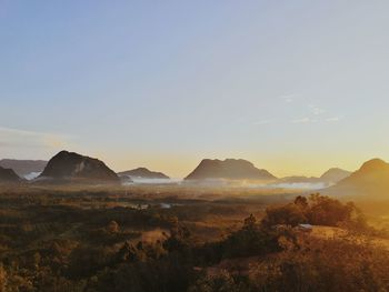 Scenic view of landscape against clear sky during sunset