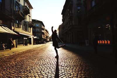 Full length of woman walking on city street
