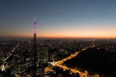 High angle view of illuminated buildings against sky at night