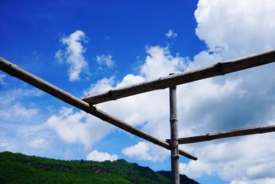 Low angle view of metallic structure against blue sky