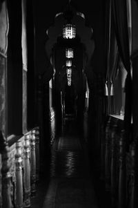 Illuminated alley amidst buildings at night
