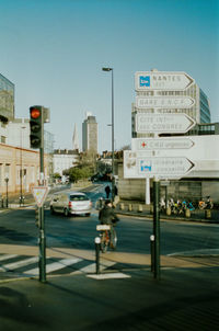 Traffic on road in city against clear sky