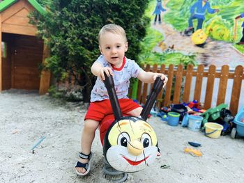 A little cute boy of one and a half years plays with toys at the playground. toddler boy