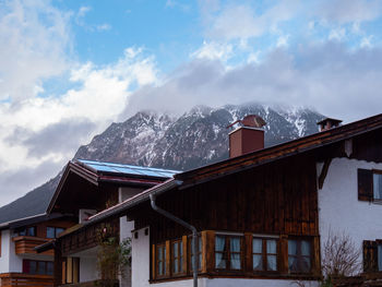 Low angle view of buildings against sky during winter