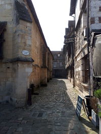 Empty alley amidst buildings in city