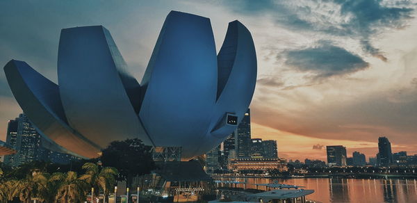 Modern buildings against sky during sunset in city