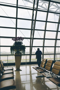 Rear view of man standing in airport