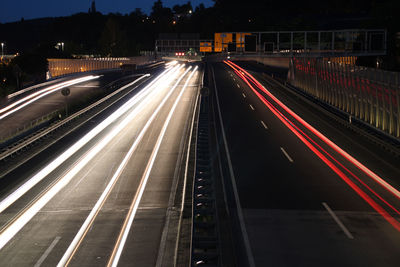 High angle view of light trails on road at night