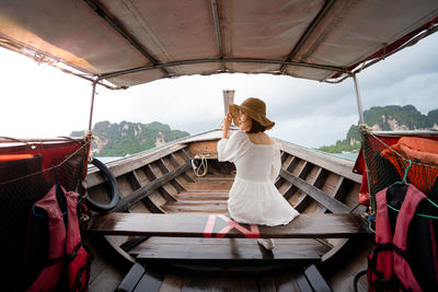 Rear view of woman standing against the sky