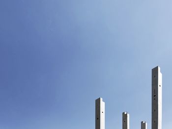 Low angle view of factory against clear blue sky