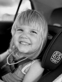 Portrait of cute girl sitting in car