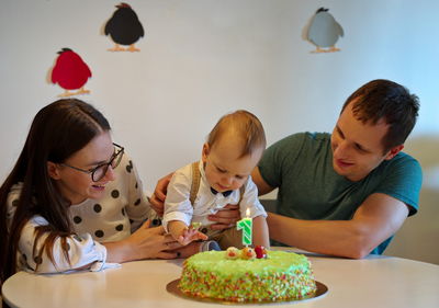 Couple and their cute little boy celebrating his first birthday