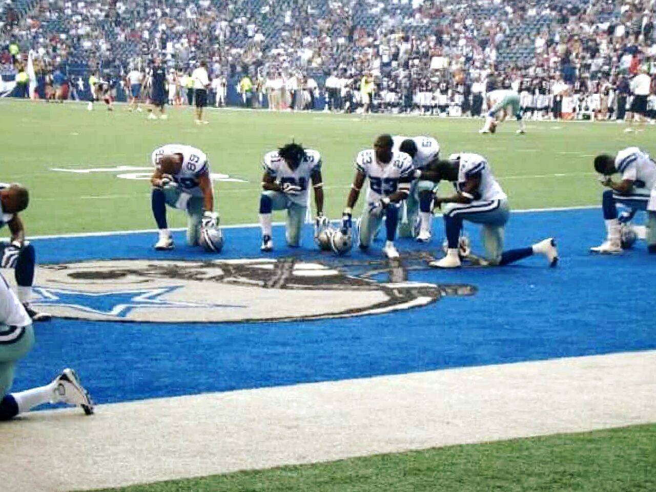 GROUP OF PEOPLE PLAYING ON THE GROUND