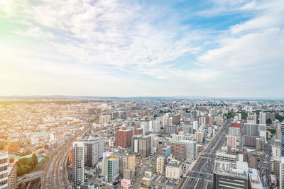 High angle view of city buildings against sky