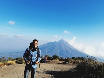 Full length of man standing on mountain against sky