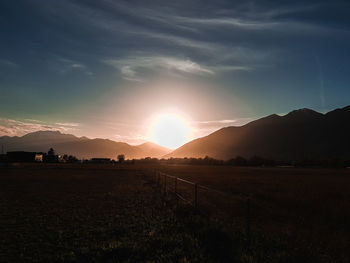 Scenic view of field against sky during sunset