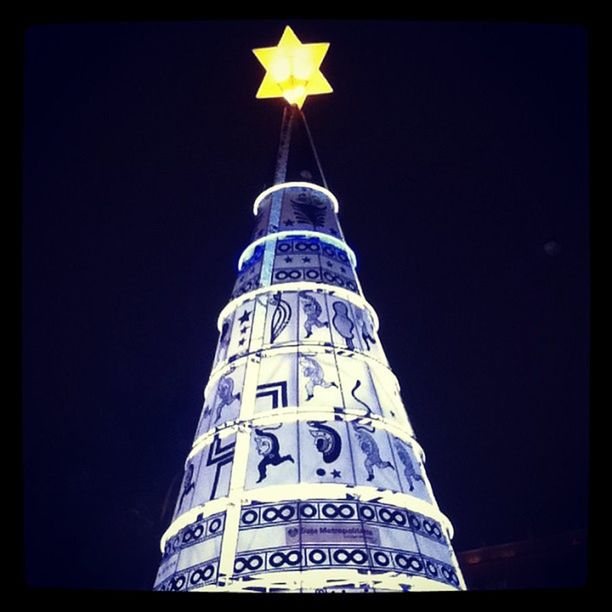 low angle view, transfer print, clear sky, blue, night, auto post production filter, tower, illuminated, copy space, architecture, built structure, building exterior, tall - high, famous place, international landmark, communication, capital cities, travel destinations, no people, vignette