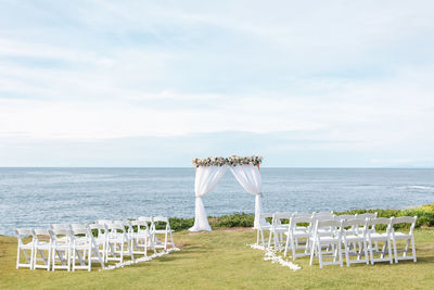 Beach destination wedding - ceremony arch and chairs on the beach