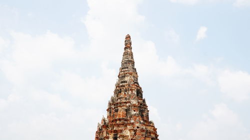 Low angle view of statue of temple against cloudy sky