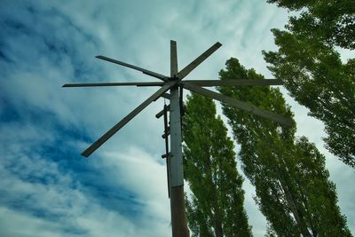 Low angle view of cross on tree against sky