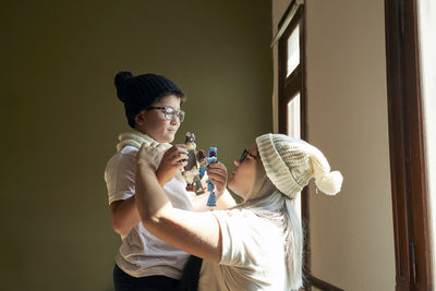 Boy with glasses looks at his mother