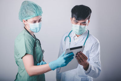 Nurse showing digital tablet to doctor in hospital