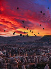 Scenic view of hot air balloons against sky during sunset