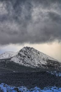 Scenic view of snow covered mountains against sky